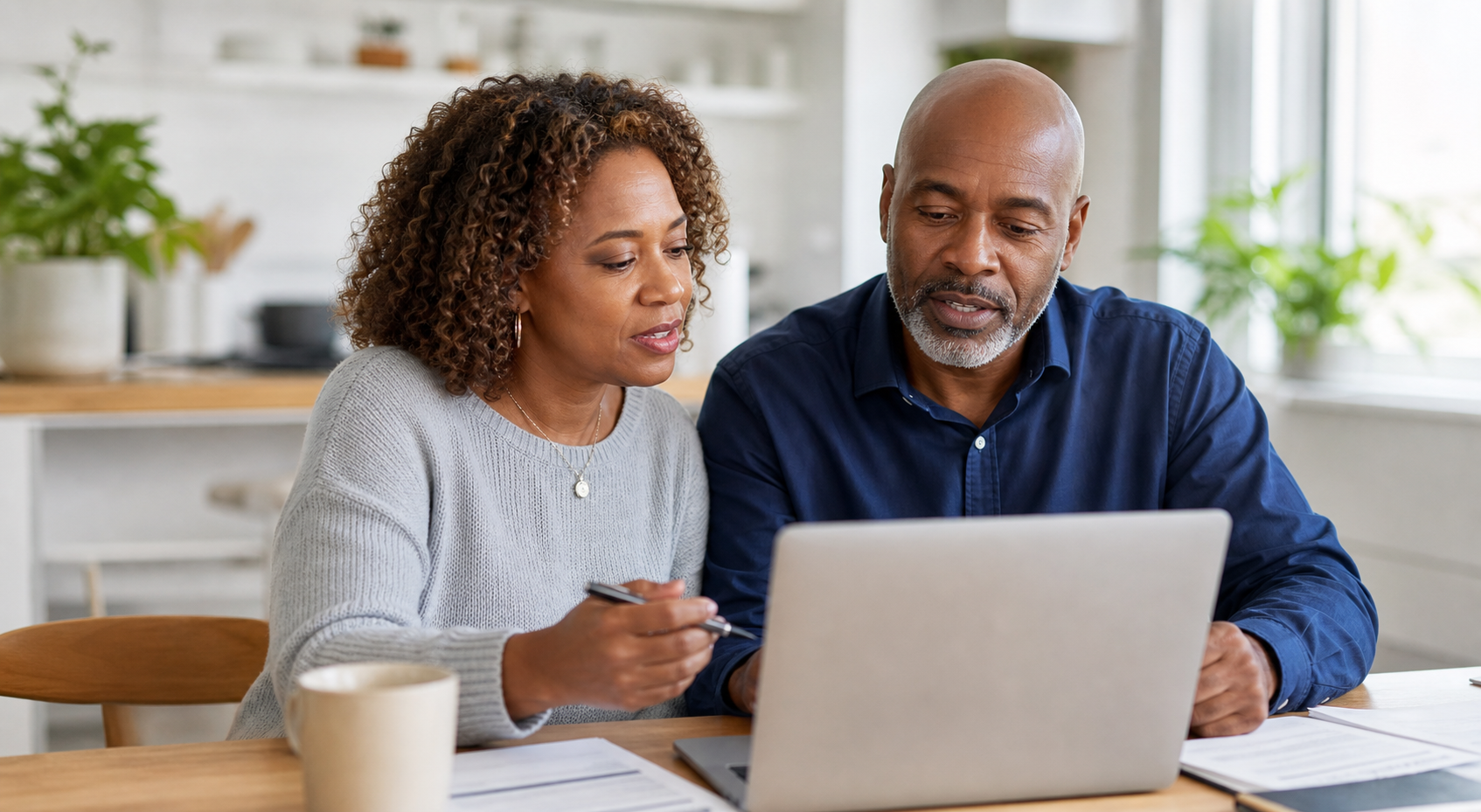 Older professionals reviewing health coverage options on a laptop